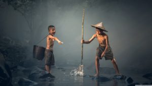 Boy Catching Fish with a Spear