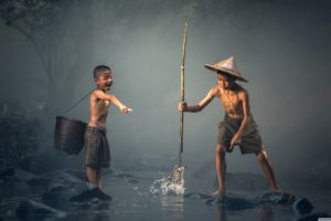 Boy Catching Fish with a Spear