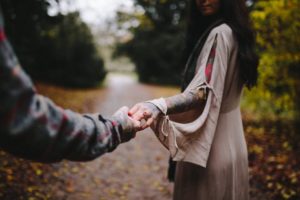Close-up Photo Of Couple Holding Hands