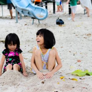 2 Girls Sitting on Seashore