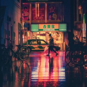 Woman in Illuminated City at Night