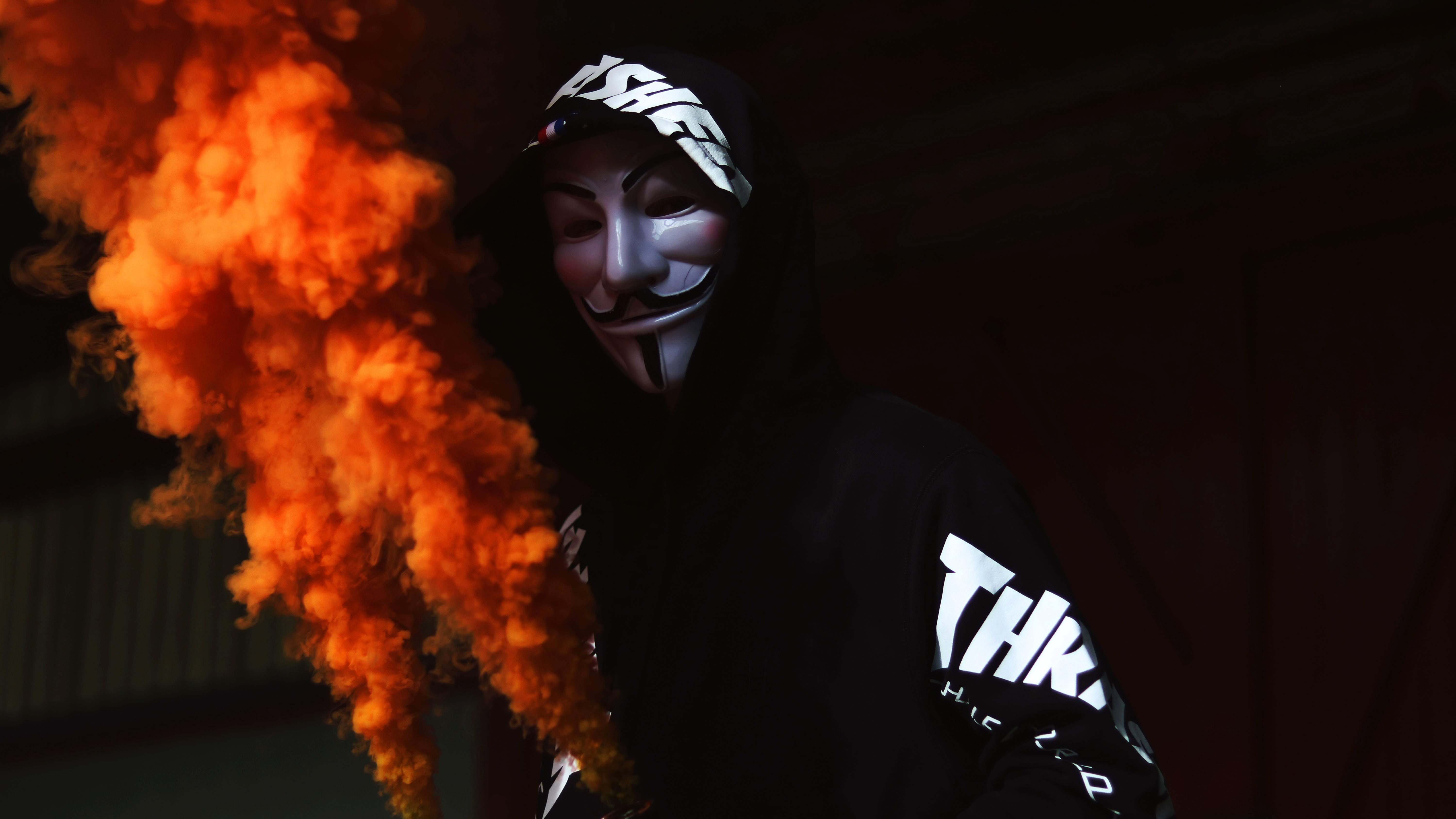 Man with Mask holding Smoke 5K