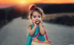 Little Cute Girl Is Standing In The Road Wearing Aquamarine Dress And Having Bag In Hand In A Blur Sunset Background HD Cute