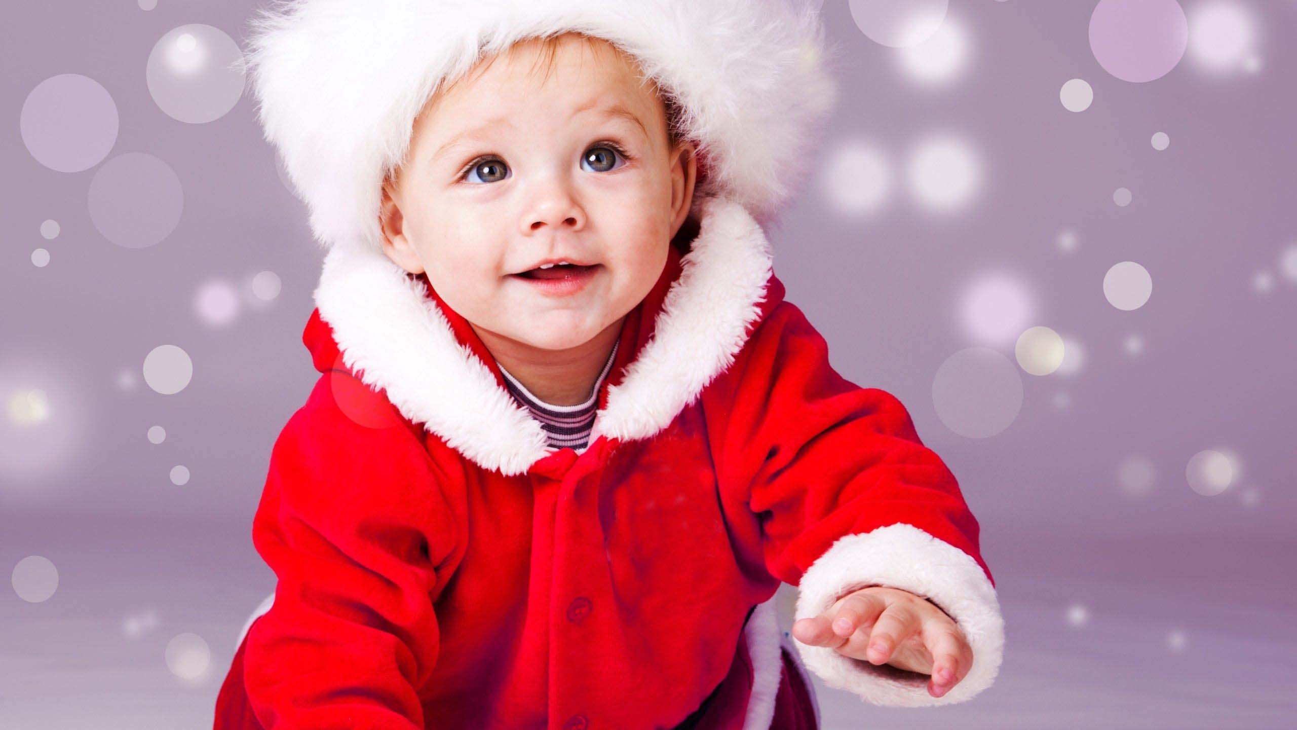 Smiley Cute Baby Boy Is Crawling On Floor Wearing Santa Dress In Bubbles Background HD Cute