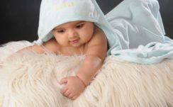Smiley Cute Baby Boy Is Lying Down On Woolen Bed Covered With Head Towel 4K HD Cute