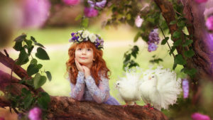 Little Cute Girl Is Holding Face With Hand Looking Up Leaning On Tree Trunk With Pigeon Nearby Wearing Redhead Wreath HD Cute