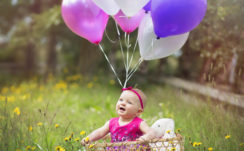 Smiley Cute Baby Is Sitting Inside Bamboo Basket On Green Grass Wearing Pink Dress With Balloons HD Cute