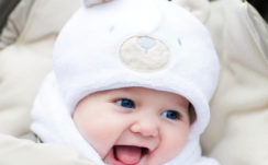 Blue Eyes Cute Baby Is Wearing White Dress And Cap Cute