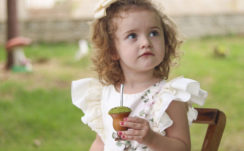 Cute Little Girl Is Wearing White Dress Sitting In Blur Green Background HD Cute